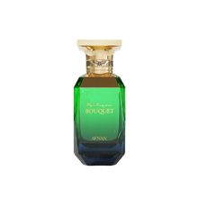 The image displays a perfume bottle from Afnan Perfumes, specifically the "Mystique Bouquet" fragrance. The bottle has a striking geometric shape with a broad, gold-colored cap. Its upper section is adorned with a decorative gold band featuring an intricate, interwoven design. The glass transitions from a transparent green at the top to a deep blue at the base, suggesting a gradient effect. The perfume's name, "Mystique Bouquet," is written in elegant script on the bottle.