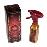 The image features two items, a box and a spray bottle, both for the product "Nasaem" air freshener. The box on the left is a tall rectangle with a dark maroon background and ornate golden and red designs, featuring the name "Nasaem" in a large oval in the center with the tagline "Air Freshener Water-Based Alcohol-Free 300 ml" below it. The brand "nabeel" is at the bottom. The spray bottle on the right has a golden body and a dark maroon trigger and nozzle. 