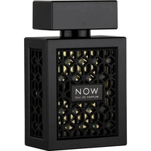 The image features a black perfume bottle with a distinctive design:  The bottle is square-shaped with a flat, rectangular black cap. It features a black geometric lattice design on the front, revealing a gold backdrop. Centered on the lattice is a white label with the text "NOW EAU DE PARFUM" in bold lettering. The design of the bottle exudes a contemporary and stylish look, suggesting a luxury fragrance.