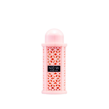 A cylindrical pink perfume bottle with a domed cap and a geometric lattice design, labeled ‘Now Women’ by Rave Lattafa.