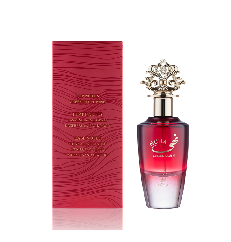 A red gradient glass perfume bottle labeled 'Nuha Cherry Blush,' featuring an ornate gold crown cap, displayed alongside a matching red box with wavy embossing and listed fragrance notes.