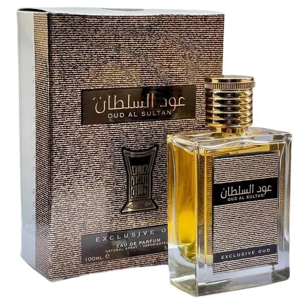 The image shows a perfume product titled "Oud Al Sultan". It features a clear glass square bottle filled with a yellow-amber colored liquid and a ribbed gold cap. The front of the bottle has a black label with gold trim and Arabic script, as well as the English translation of the product name "Oud Al Sultan" and the words "Exclusive Oud". Behind the bottle is its packaging box, which has a textured gold and black design.