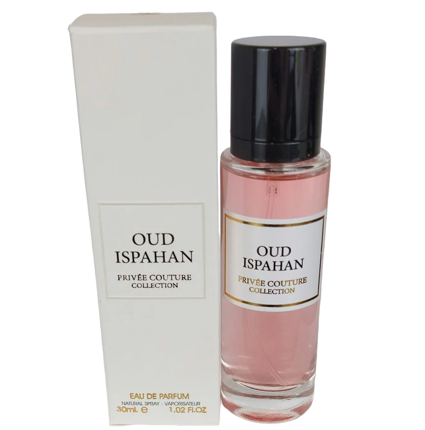 The image features a perfume set from the Privée Couture Collection named "OUD ISPAHAN." On the left is the outer packaging, a tall, slender rectangular box in a soft off-white color with a framed label matching the bottle's label. On the right side stands the perfume bottle, a clear cylindrical container with a rosy pink fragrance liquid. It has a black cap, and the label on the bottle is bordered and reads "OUD ISPAHAN PRIVÉE COUTURE COLLECTION" in black lettering on a cream background.