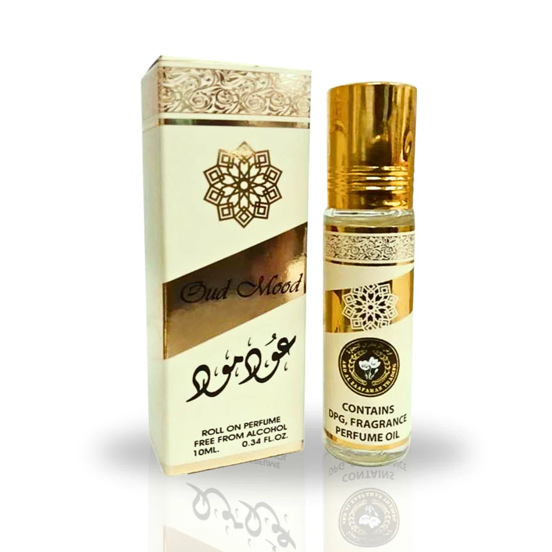 A product image featuring a roll-on perfume called "Oud Mood" by Ard Al Zaafaran. The perfume bottle is 10ml in size and free from alcohol. The bottle has a golden cap and intricate gold design patterns on the label. The packaging box has similar gold patterns and Arabic text below the English product name.