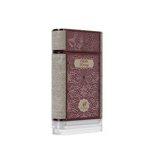 The image features a perfume bottle with an elegant and intricate design. The rectangular bottle has a flat profile and is predominantly colored in dark maroon with an ornate embossed pattern that covers the majority of the front and back surfaces. This pattern is reminiscent of traditional Middle Eastern art, giving the bottle a luxurious and cultural aesthetic.  The bottle's cap is maroon and complements the overall design. The image is set against a clean white background.