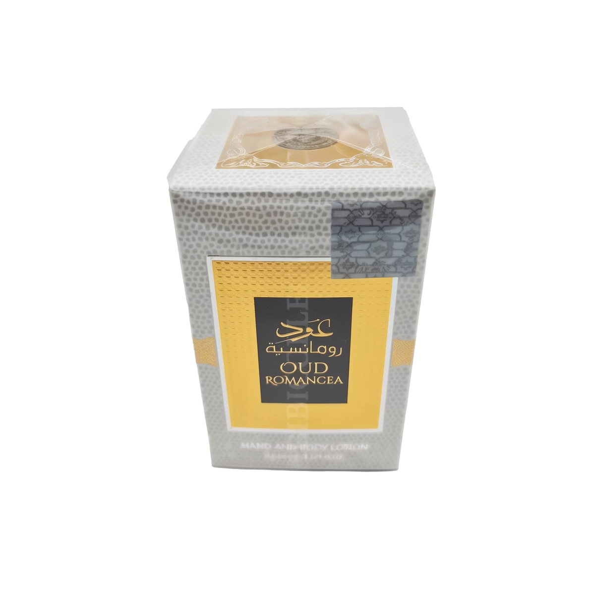 The image features a box of OUD ROMANCEA hand and body lotion. The box has a textured gray pattern resembling reptile skin, with a bold yellow band across the center featuring the product name in both Arabic and English. At the top of the box, there is a transparent section revealing a golden emblem design, while the lower part includes details about the product in smaller text. The overall design of the packaging suggests a luxurious and exotic product.