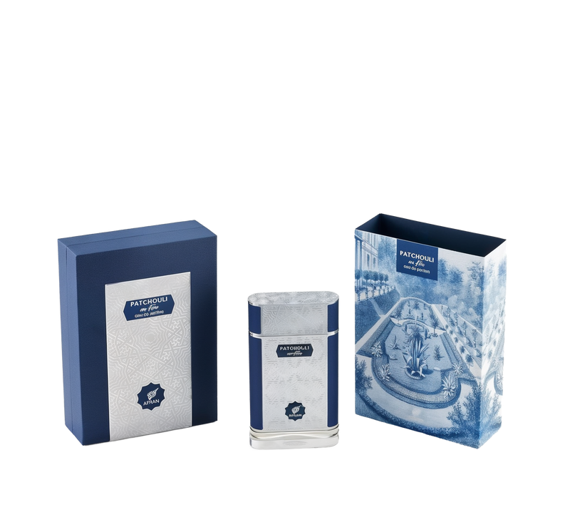 The image showcases a set of perfume products with their packaging. There are two boxes and one perfume bottle, all with a consistent color theme of navy blue and white. The box on the left is navy blue with a textured pattern and a white label that reads "PATCHOULI eau de parfum" along with the "AFNAN" logo.  To the right is another box with a detailed blue and white illustration of a classical garden scene, including a fountain and neatly trimmed hedges.