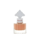 The image features a clear glass perfume bottle filled with a peach-colored liquid. The bottle has a white cap with the word "PEACH" in a peach font color. Atop the cap is an ornate white design, detailed and intricate, possibly inspired by Middle Eastern art.