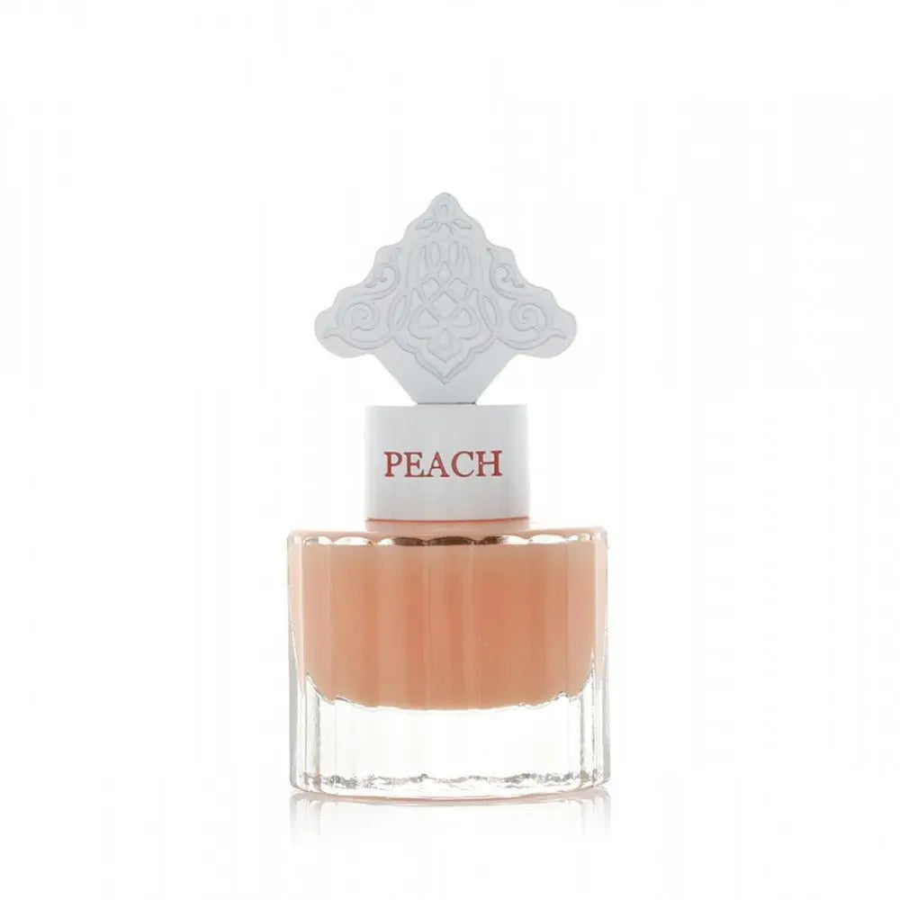 The image features a clear glass perfume bottle filled with a peach-colored liquid. The bottle has a white cap with the word "PEACH" in a peach font color. Atop the cap is an ornate white design, detailed and intricate, possibly inspired by Middle Eastern art.