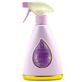 The image shows a light purple spray bottle for "KAUSAR" perfume, which is part of the AQUA series. The bottle features a white spray nozzle with a purple actuator and a distinctive teardrop-shaped transparent window that showcases the name "KAUSAR" in Arabic script and "AQUA" in Latin script. The label inside the window has a purple background, and there's a yellow base that adds a contrasting color accent. The background of the image is white, emphasizing the pastel color and elegant design of the bottle.