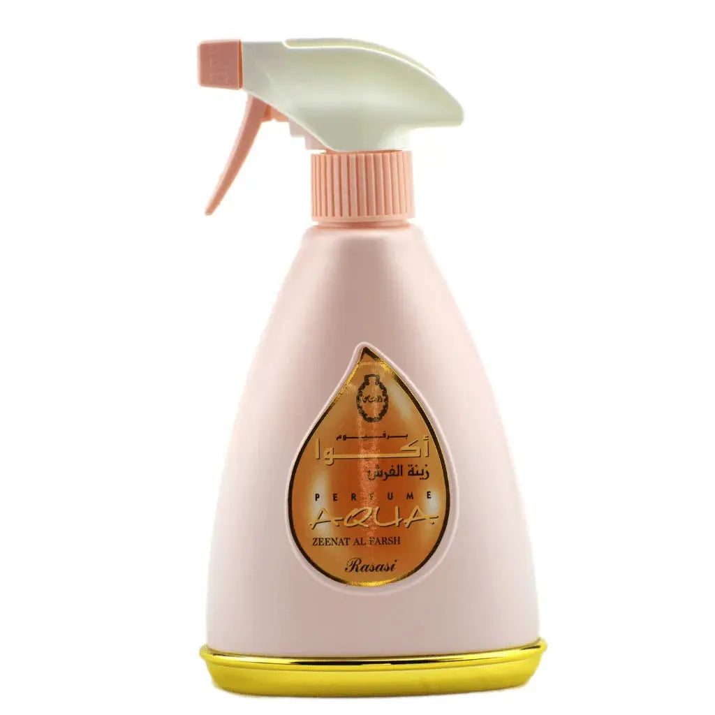 The image shows a peach-colored spray bottle for "ZEENAT AL FARSH" perfume, which is part of the AQUA series. The bottle features a white spray nozzle with a peach actuator and a gold-colored base. A teardrop-shaped transparent window on the bottle displays the name "ZEENAT AL FARSH" in Arabic script and "AQUA" in Latin script, set against a gold and orange backdrop. The design is elegant and modern, with the background of the image being plain white to emphasize the product's colors and design details.