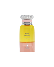 A tall, cylindrical perfume bottle with a metallic swirl cap, featuring a yellow top transitioning to a pink base, labeled ‘Pink Velvet Eau De Parfum’ by Maison Alhambra, with a deer logo at the bottom.