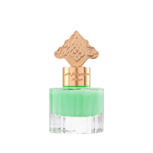 This is an image of a perfume bottle with a clear base and a vibrant green liquid inside. The cap is ornate and gold-colored, featuring an intricate design that suggests an inspiration from Middle Eastern or Islamic art. There is Arabic calligraphy on the gold band around the neck of the bottle, likely indicating the fragrance's name or brand.