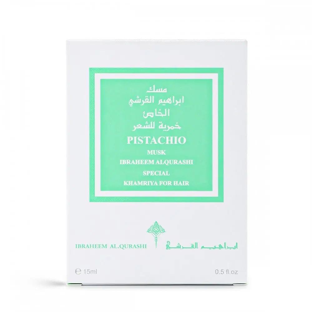 The image displays a fragrance product's packaging box. The box is white with a bright green label framed within a larger white border. The label contains text in both English and Arabic, indicating the fragrance name "PISTACHIO MUSK," the brand "IBRAHEEM AL QURASHI SPECIAL," and the product type "KHAMRIYA FOR HAIR." The box also notes the quantity as "15ml / 0.5 fl.oz."