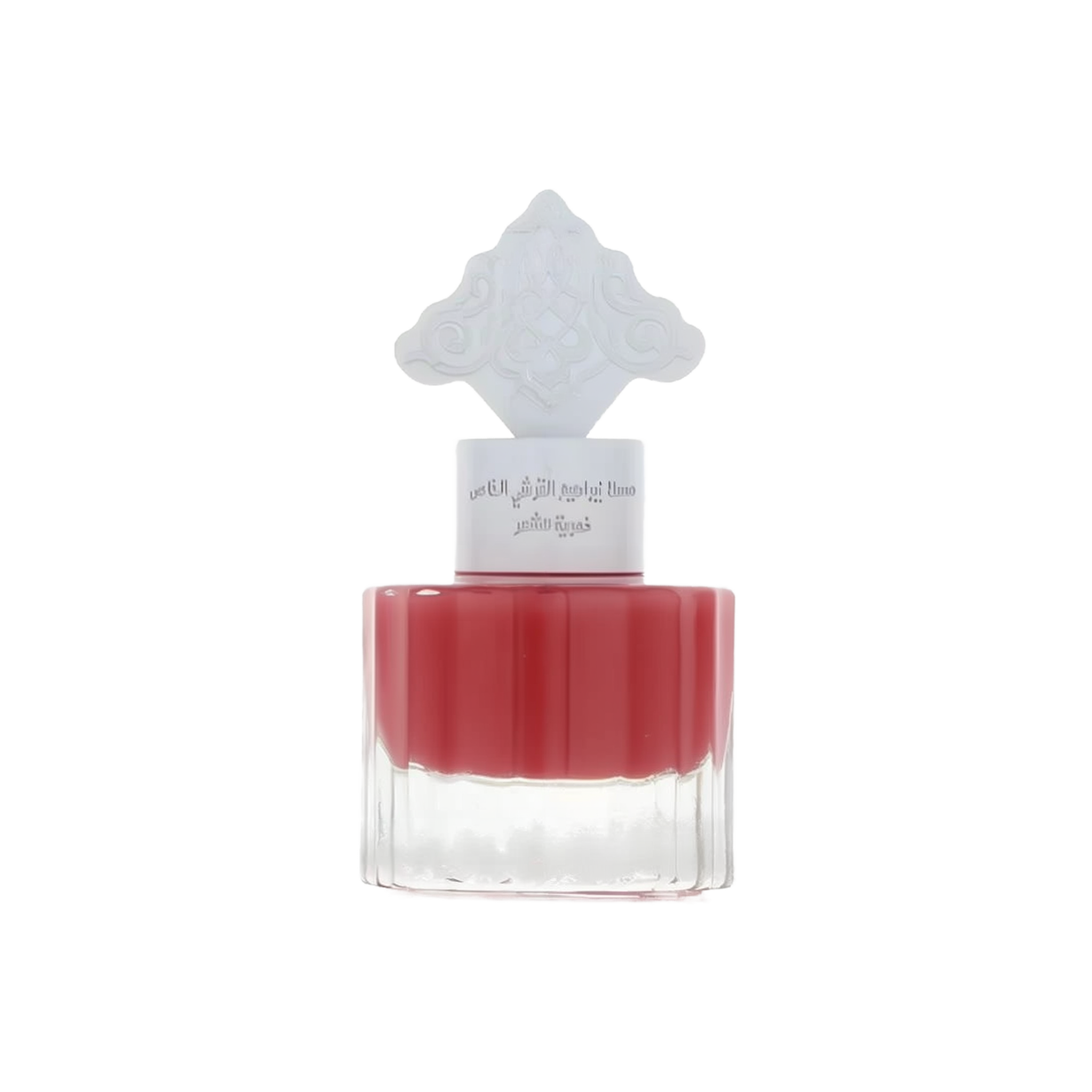 The image shows a perfume bottle with a red liquid and a white cap that has an intricate arabesque design. The label on the bottle, likely in Arabic, suggests that it is a fragrant product intended for hair, possibly part of a special collection by Ibraheem Al.Qurashi. The clear bottom half of the bottle allows the rich red color of the liquid to be prominently displayed, indicating a pomegranate-themed fragrance. The overall design is minimalistic yet elegant.