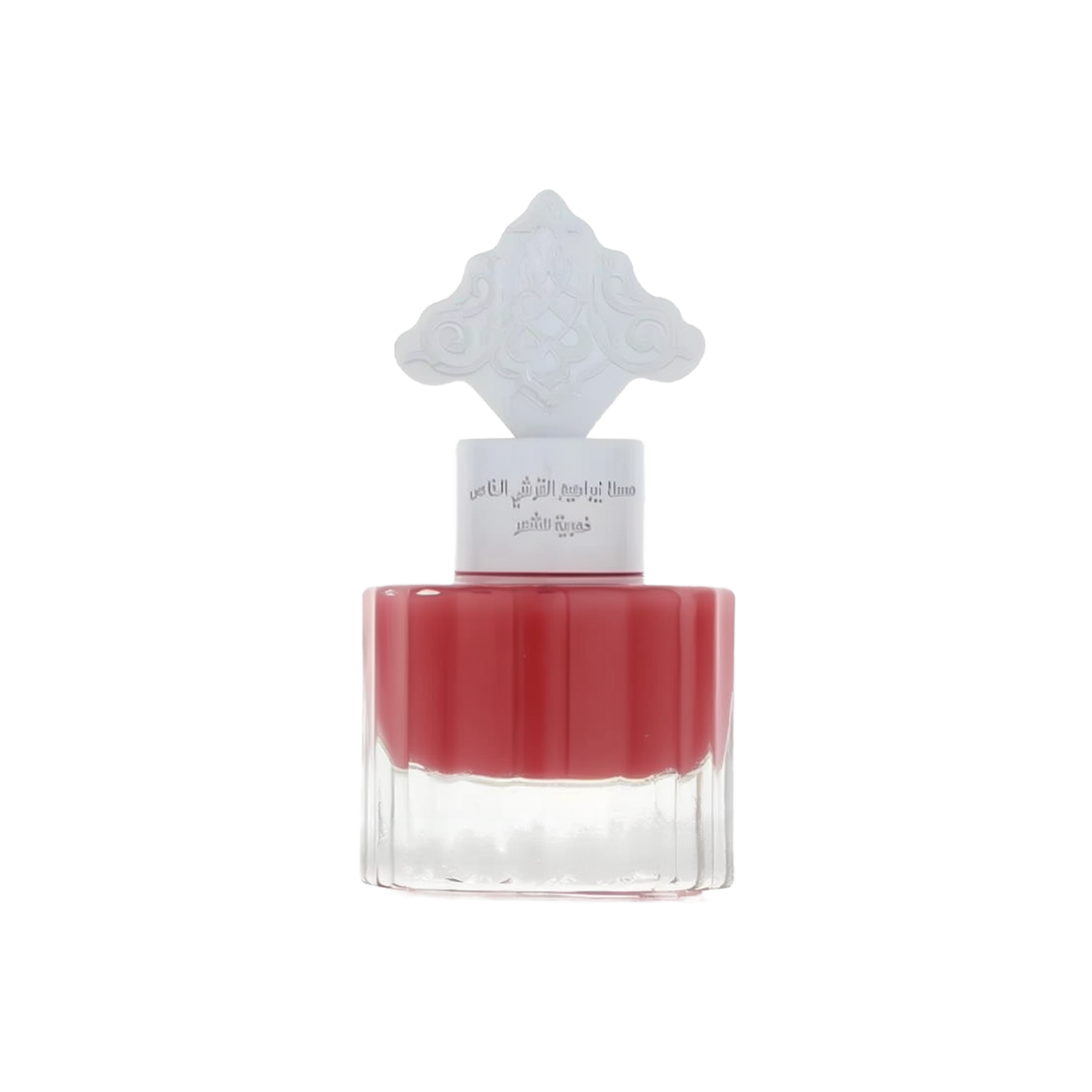 The image shows a perfume bottle with a red liquid and a white cap that has an intricate arabesque design. The label on the bottle, likely in Arabic, suggests that it is a fragrant product intended for hair, possibly part of a special collection by Ibraheem Al.Qurashi. The clear bottom half of the bottle allows the rich red color of the liquid to be prominently displayed, indicating a pomegranate-themed fragrance. The overall design is minimalistic yet elegant.