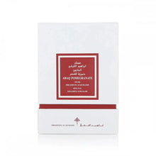 The image displays a white square box with a deep red label framed in gold, indicating a luxury hair product named "ABAQ POMEGRANATE MUSK" by Ibraheem Al Qurashi. This product appears to be part of a special "KHAMRIYA" collection for hair care. The text on the box is likely in both Arabic and English, denoting an exclusive or premium range. 