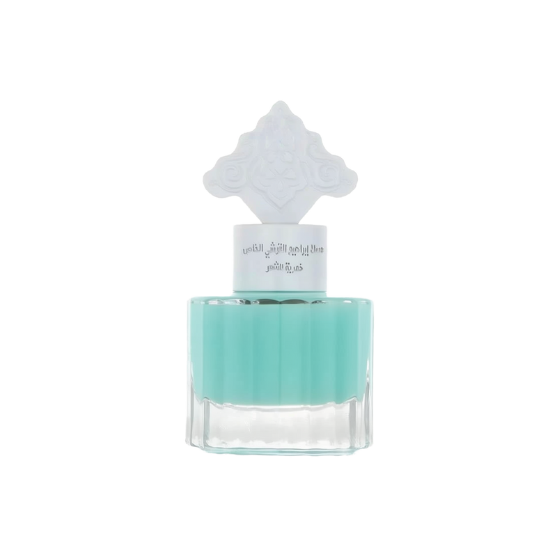 The image features a transparent glass bottle filled with a teal-colored liquid, suggesting a fragrance or scented product. The bottle has a unique, white ornate cap that resembles traditional Middle Eastern pattern.