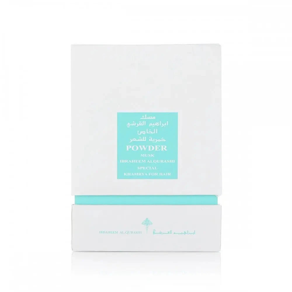 The image shows a white box with a teal label, which is likely the packaging for a fragrance or hair care product. The label features both English and Arabic text, reading "POWDER MUSK" and "IBRAHEEM AL QURASHI SPECIAL KHAMRIYA FOR HAIR." 