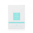 The image shows a white box with a teal label, which is likely the packaging for a fragrance or hair care product. The label features both English and Arabic text, reading "POWDER MUSK" and "IBRAHEEM AL QURASHI SPECIAL KHAMRIYA FOR HAIR." 