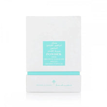The image shows a white box with a teal label, which is likely the packaging for a fragrance or hair care product. The label features both English and Arabic text, reading "POWDER MUSK" and "IBRAHEEM AL QURASHI SPECIAL KHAMRIYA FOR HAIR." 