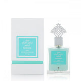 The image features a perfume bottle alongside its packaging. The bottle contains light blue liquid and has a silver decorative cap with an arabesque design. The label, both on the bottle and the white box, has teal borders with text in Arabic and English reading "POWDER MUSK, IBRAHEEM ALQURASHI SPECIAL". The box is slightly taller than the bottle, with a matching teal color at its base, and stands against a white background.