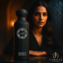 Black Gissah Mavro perfume bottle with woman blurred in background.