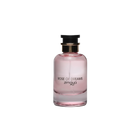 The image shows a bottle of "Rose of Dreams" eau de parfum by Zimaya. The perfume bottle is cylindrical with a soft pink hue and a clear glass bottom. It features a black cap with a gold band. The front of the bottle has black text that reads "ROSE OF DREAMS" and "zimaya." The overall design is elegant and minimalist, with the soft pink color evoking a sense of femininity and romance.
