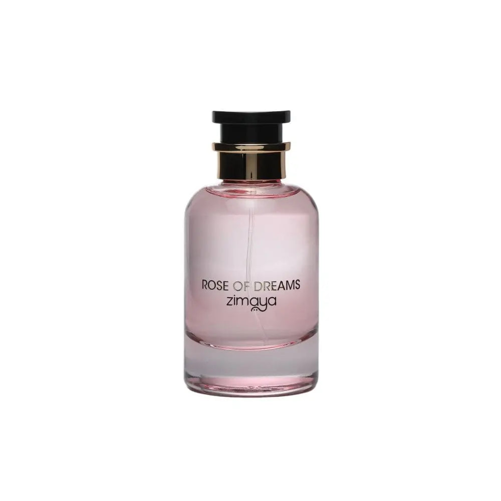 The image shows a bottle of "Rose of Dreams" eau de parfum by Zimaya. The perfume bottle is cylindrical with a soft pink hue and a clear glass bottom. It features a black cap with a gold band. The front of the bottle has black text that reads "ROSE OF DREAMS" and "zimaya." The overall design is elegant and minimalist, with the soft pink color evoking a sense of femininity and romance.