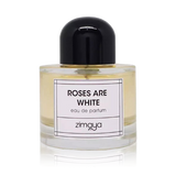 The image shows a bottle of "Roses Are White" eau de parfum by Zimaya. The perfume bottle is cylindrical and made of clear glass, showcasing a pale yellow liquid inside. It features a simple, modern design with a black cap. The front of the bottle has a white label with black text that reads "ROSES ARE WHITE" and "eau de parfum," along with the brand name "zimaya" at the bottom.