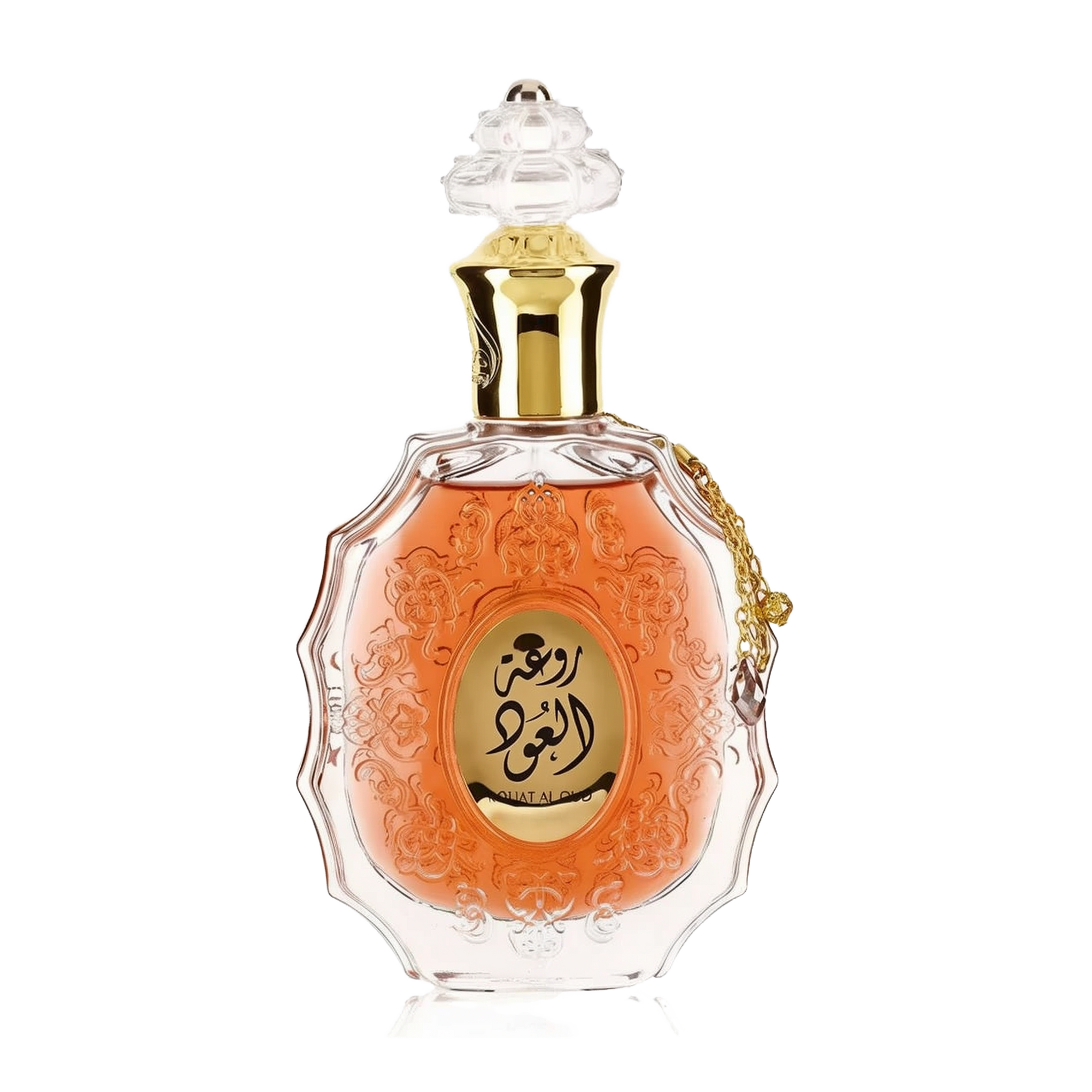 he image features an ornate perfume bottle:  The bottle is made of clear glass with a decorative texture and a central amber-colored panel. A clear and intricate glass stopper tops the bottle. A golden metallic chain with a charm is attached to the neck of the bottle. Arabic calligraphy is featured within the amber panel, and the name "ROUAT AL OUD" is inscribed in English below the calligraphy.