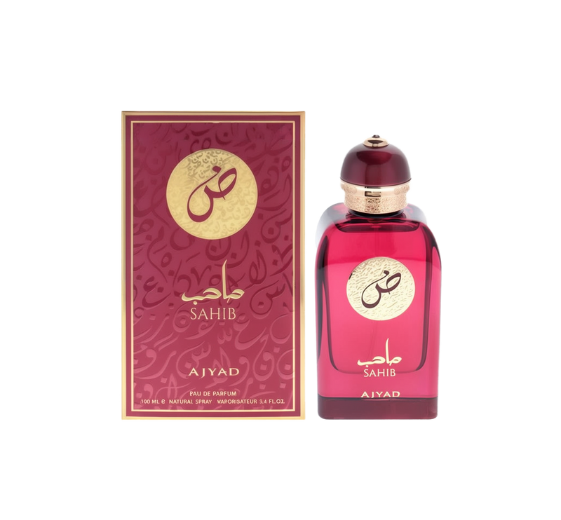 A rectangular deep red perfume bottle with gold Arabic text reading “Sahib” and a dome-shaped cap, shown alongside a matching red and gold box labeled “Sahib” and “Ajyad.”