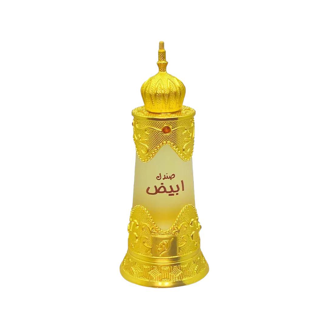 he image shows an ornate perfume bottle with a frosted glass body that graduates from a translucent white at the top to a clear bottom. The bottle is adorned with elaborate gold patterns and motifs that give it a rich, luxurious appearance. At the base, there's a detailed golden ring featuring intricate designs and figures. The cap is equally ornamental, resembling a small dome with a finial, indicative of Middle Eastern architectural influences.