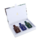 This image features a luxurious white box open to reveal a trio of DKHAN Fragrances Eau de Parfum bottles. The set includes a maroon bottle, a cobalt blue bottle, and an emerald green bottle, each with a marbled finish and capped with a matching geometric lid. The bottles are neatly arranged in a row, cushioned within the plush white interior of the box. The box lid interior has a decorative marbled trim at the edges and is stamped with the DKHAN Fragrances logo—a triangle with a heart inside.