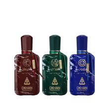 This image features a set of three distinct perfume bottles from DKHAN Fragrances, each containing 50ml of Eau de Parfum. From left to right: the first bottle is maroon with a matching geometric cap and a gold tag, the second bottle is emerald green with a gold tag, and the third is cobalt blue with a gold tag. Each bottle has a marbled effect and is adorned with the DKHAN logo and 'INTENSE' in gold lettering, along with the brand's emblem, a heart within a diamond shape.