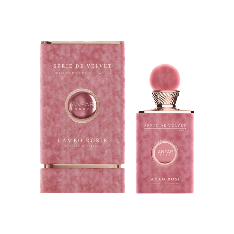 The image displays the "Cameo Rosie Extrait De Parfum" from the "Serie De Velvet" collection by Anfar. The perfume bottle has an elegant, velvety pink finish, matching the texture of the packaging box beside it. The bottle is topped with a soft pink spher