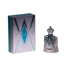 The image displays a perfume bottle next to its packaging. The packaging is a tall rectangular box with a silver color scheme and features a pattern that mimics the design of the bottle, with a central V-shaped motif outlined in blue. The bottle itself is crafted with intricate silver detailing, resembling a piece of filigree work, and is adorned with bright blue gemstones arranged in two parallel V-shaped lines that accentuate the bottle's design. 
