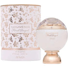 The image displays a perfume bottle and its cylindrical packaging. The bottle has a spherical white body with "SOUVENIR Floral Bouquet AFNAN" written in a gentle script. It features a clear dome on top, under which a golden substance can be seen, giving a luxurious touch to the design. The packaging repeats the rose gold theme with a soft pink and gold floral pattern.  The overall design of the product and packaging evokes a sense of delicate, luxury and femininity.