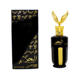 The image features two items against a white background: on the left, a tall, black perfume box with golden embossed doves and lettering for "AL HUR SO INTENSE EAU DE PARFUM 100mL 3.4FL.OZ" by Ard Al Zaafaran, and a diagonal design revealing a black layer underneath. The combination of black and gold conveys a sense of luxury and opulence. 