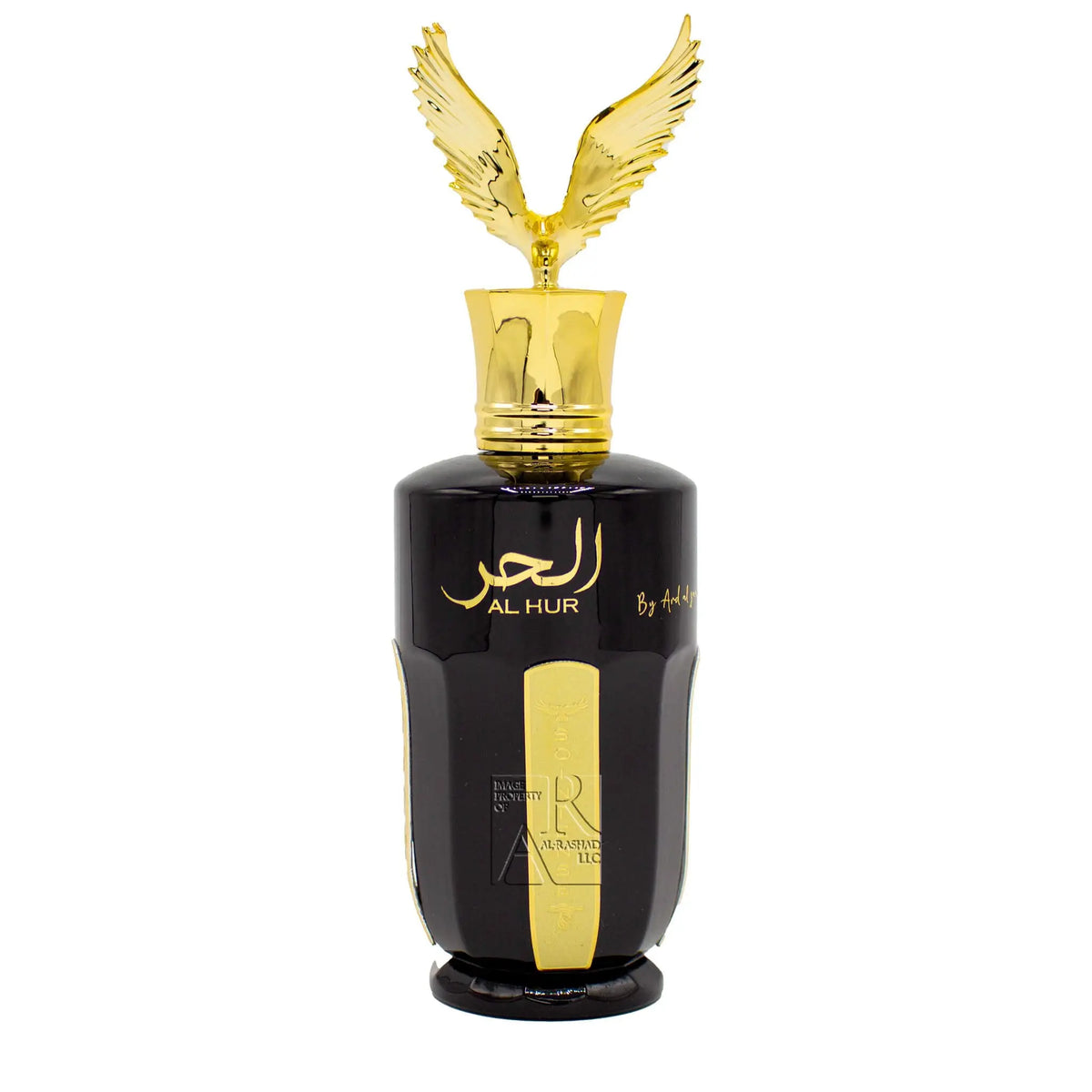 The image displays a perfume bottle with a sleek, glossy black finish and a golden cap featuring two extended wings. The cap and wings have a polished, metallic sheen, suggesting a luxurious feel. On the front of the bottle, there is elegant gold script, possibly Arabic, with the words "AL HUR" written below it, suggesting it is the name of the fragrance or brand, along with a vertical, golden label