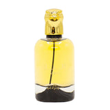 The image displays a perfume bottle with these characteristics:  The bottle is transparent with a bright yellow liquid inside, filling approximately the top two-thirds of the bottle. The bottom third of the bottle contains a darker substance, creating a contrast with the yellow liquid above. The cap is a reflective gold and features a stylized animal figure, possibly a lion or a mythical creature, as the topper.