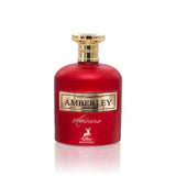 The image features a luxurious red perfume bottle with a golden cap. The front of the bottle has a gold label with the name "AMBERLEY" inscribed on it, and below is the word "amoroso" in cursive, along with a small gold emblem depicting a deer, indicating it may be the logo for "Maison Alhambra". The bottle's vibrant red color and golden accents suggest a rich and opulent fragrance. The background is a plain white, accentuating the bottle's bold colors.