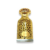 The image is of a perfume bottle, likely around 100ml in volume. The bottle is ornate with a lattice design, predominantly gold in color, with a polished finish. The label "EMEER" is embossed in the center on a golden plaque, suggesting it is the name or brand of the fragrance. The bottle cap is a solid gold color, matching the style of the bottle, and seems to be removable. The bottom part of the bottle appears to be transparent, possibly glass, showing the liquid inside.