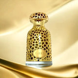 The image shows a perfume bottle with a golden lattice design on a background that features soft, wavy golden fabric, enhancing the luxurious feel of the product. The bottle has a label with the name "EMEER" prominently displayed on the lower half of the bottle. The cap of the bottle is also golden with a textured pattern that complements the lattice design. The overall presentation is rich and elegant, suggesting a high-end fragrance product.