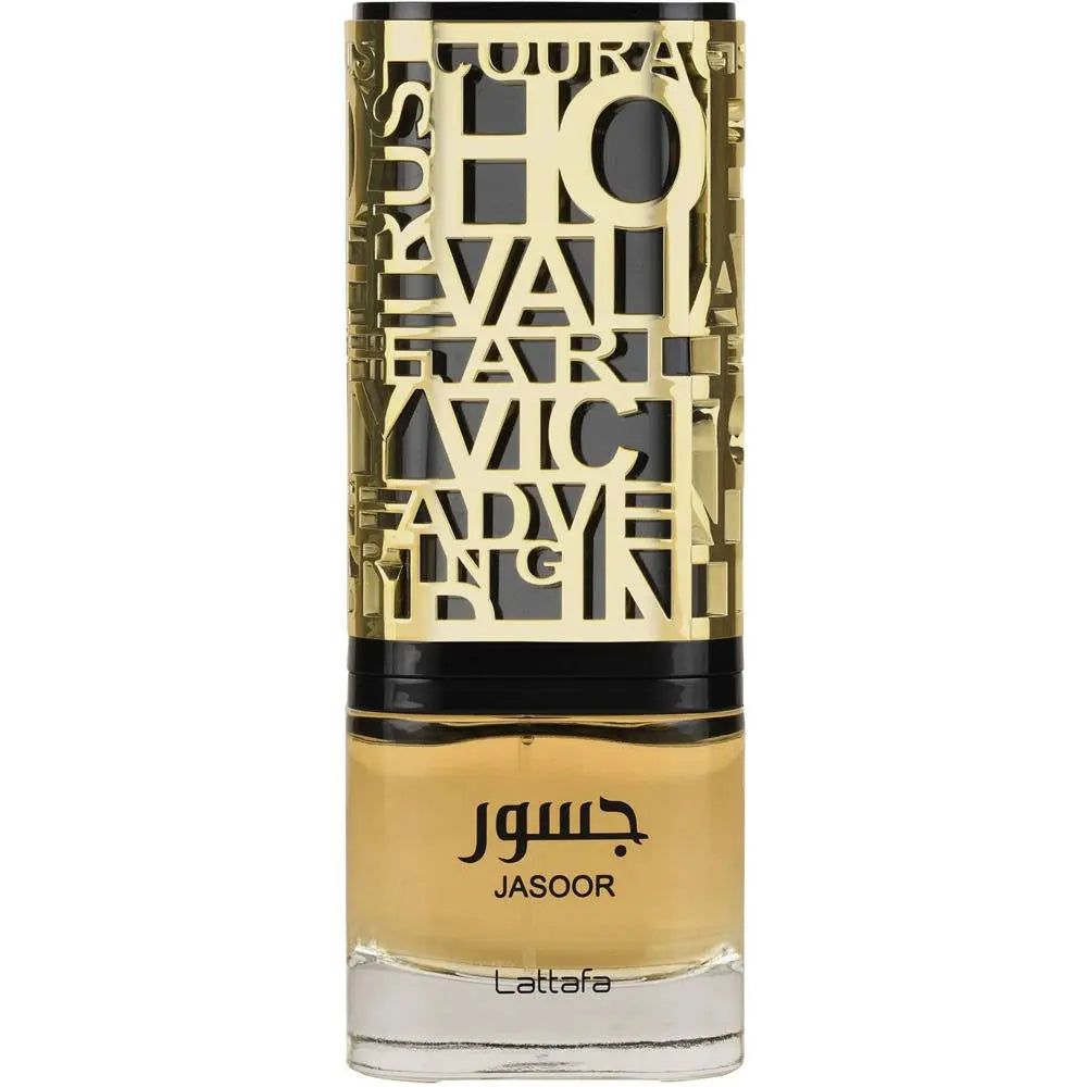 The image shows a bottle of perfume. The bottle has a clear bottom filled with yellow-amber colored liquid, presumably the fragrance. It features a detailed, ornate, gold-colored metallic overlay with cut-out letters and designs, and a black band towards the top, under the cap. The name "JASOOR" is prominently displayed in the middle of the bottle, with the brand "Lattafa" written at the bottom. The overall design suggests a luxurious and perhaps Middle Eastern-inspired aesthetic.