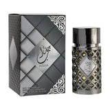 The image features a sophisticated and stylish perfume set. On the right, the perfume bottle is cylindrical with a silver lattice design over a black base, showcasing the dark liquid inside. It has a black cap, and the center of the bottle is adorned with a silver plaque that has "Jazzab" written in elegant Arabic calligraphy.  This presentation exudes elegance and would likely appeal to those looking for a bold and luxurious fragrance experience.