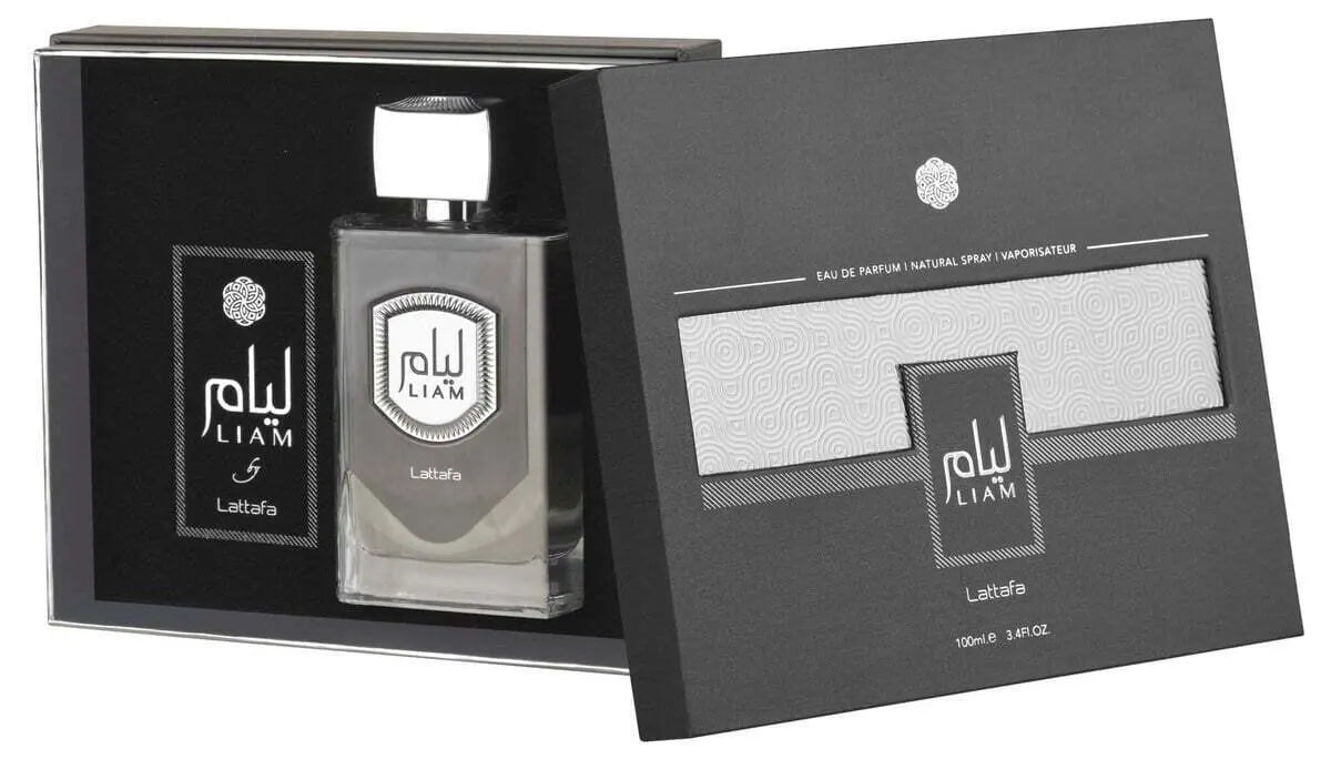 The image shows a perfume bottle and its packaging. The bottle has a clear glass body with a silver-grey liquid and a square silver-grey cap. It features a metallic label with "LIAM" in stylized letters and Arabic script. The box is black with grey patterns and design elements, including the perfume's name "LIAM" in the same style as the bottle, and the brand "Lattafa" at the bottom.