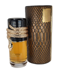The image showcases a perfume bottle alongside its packaging:  The bottle is filled with a golden-yellow liquid, likely perfume, and has a distinctive design with a gold-colored rope coiled around the neck, topped with a snakehead-shaped ornament. The cap is black, which provides a stark contrast to the gold rope and ornament. On the bottle, in elegant black script, is the name "مسامم" (Musamam) along with the brand "Lattafa." Accompanying the bottle is its cylindrical packaging.