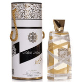The image shows a cylindrical perfume bottle with a clear body and golden-colored liquid inside. The bottle has a patterned gold cap and is wrapped with a ribbon that has the words "Musk Mood" repeatedly printed on it.  A gold rope is attached to the packaging, suggesting it can be used as a handle. The text "EAU DE PARFUM NATURAL SPRAY VAPORISATEUR 100ML 3.4 FL.OZ." is also present on the packaging.