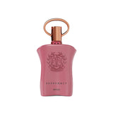 The image shows a pink perfume bottle with a metallic gold cap and a ring-shaped detail on top. The front of the bottle displays embossed text and a decorative emblem featuring the initials 'AP' in a stylized design, surrounded by a wreath-like motif. Below the emblem, the words "SUPREMACY GALA AFNAN" are printed in a simple, elegant font. The bottle has a smooth, matte finish, and there are small, pink gemstone-like embellishments around the neck.